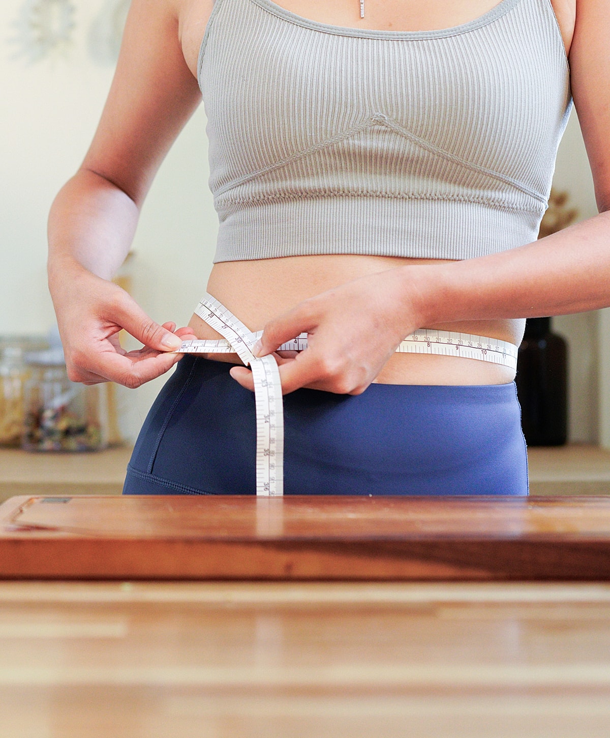 Measuring waist with a tape measure.